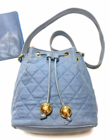 CHANEL Vintage blue quilted canvas and leather combo hobo bucket shoulder bag with drawstrings and golden CC mark balls