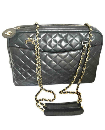 CHANEL Vintage black lamb leather large bag with double golden chain strap and a CC pull charm