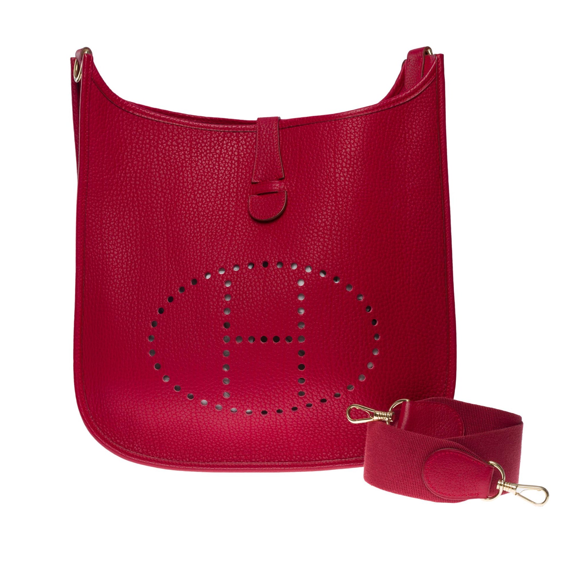 BAG EVELYNE in red Courchevel leather (30 x 33 x 7 cm)…