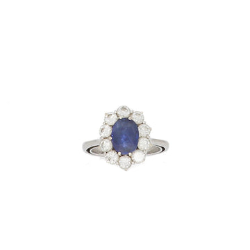 18K white gold ring set with an oval shape sapphire surrounded by brilliant-cut diamonds