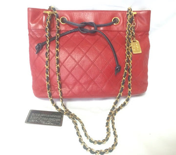 CHANEL Vintage classic tote bag in red leather with gold tone chain and navy blue leather straps and logo CC charm