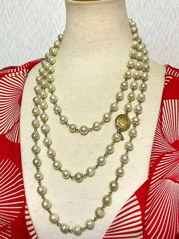CHANEL Vintage faux pearl necklace, extra long necklace with golden round logo motif