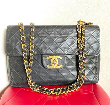 CHANEL Vintage black lamb leather large, jumbo size shoulder bag with big golden CC closure and chain strap